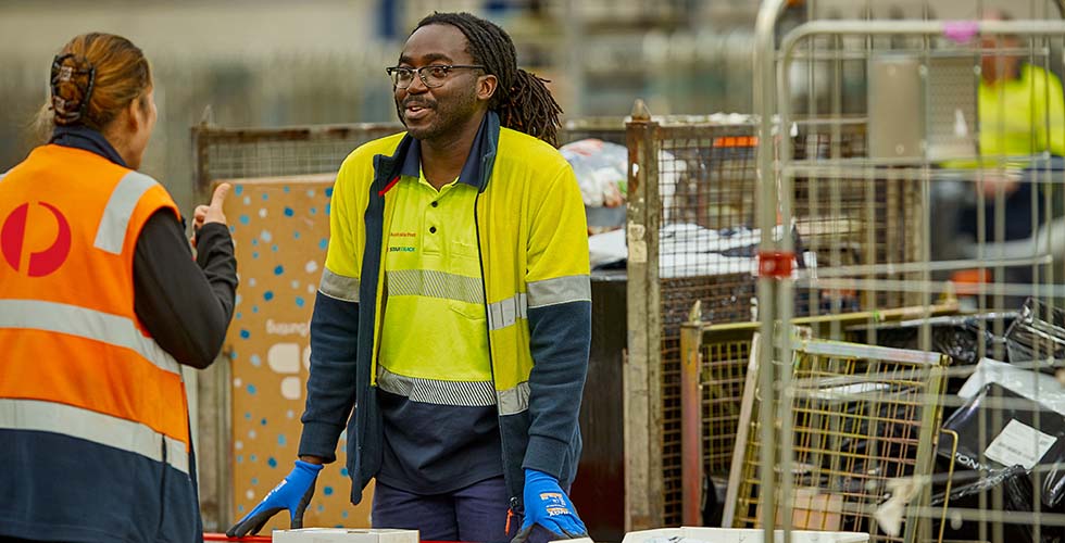 employees working in mail distribution center for australia post